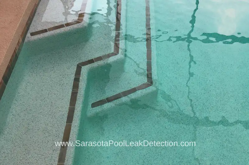 Addressing pool leaks involves targeted repair strategies, often identified through signs like cracked tiles. 
